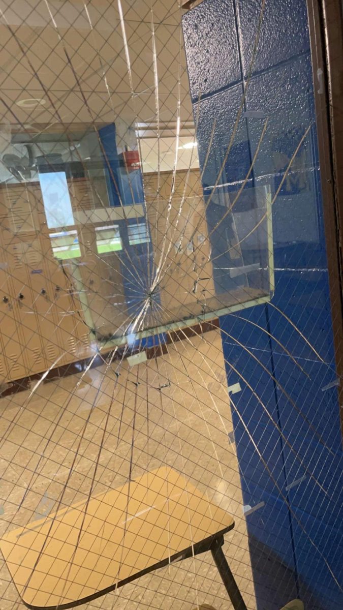 Broken glass in Mr. Rosendales room from a chair used to barricade the door during the incident.  